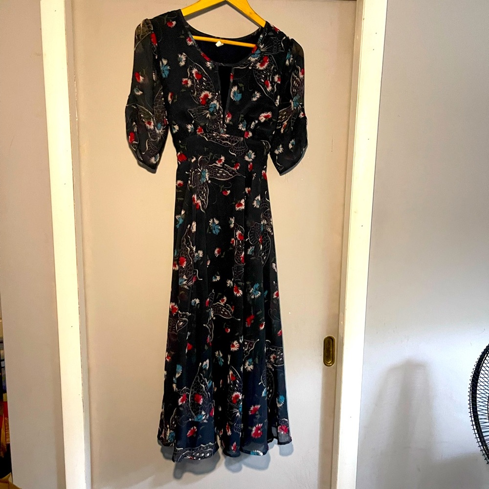 Size Large Free People dress, empire style waist, tie back. Navy w/ butterflies.